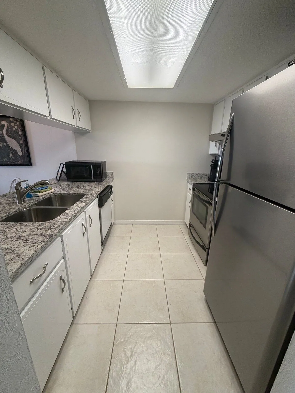Fully equipped kitchen with granite counters, stainless steel refrigerator, range, oven, dishwasher and microwave